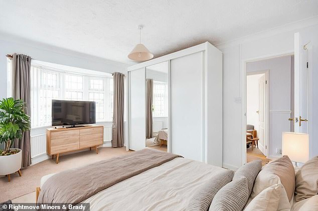 This bedroom has been enhanced with AI to brighten up the room and to add furniture - including a television that doesn't appear in the mirror and curtains with no rail