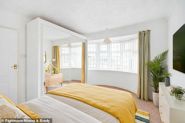 Another picture of the home featured entirely different curtains and tables in the reflection of the wardrobe mirror