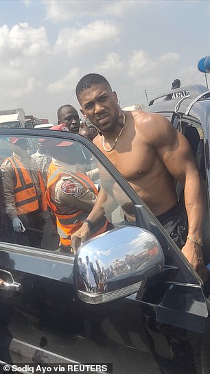Joshua pictured moments after the tragic crash took place on a major road outside Lagos