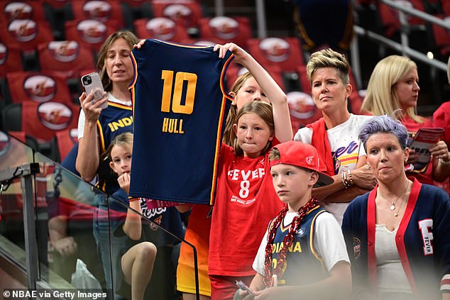 An Indiana Fever fan is seen holding up a Lexie Hull jersey prior to a game in September