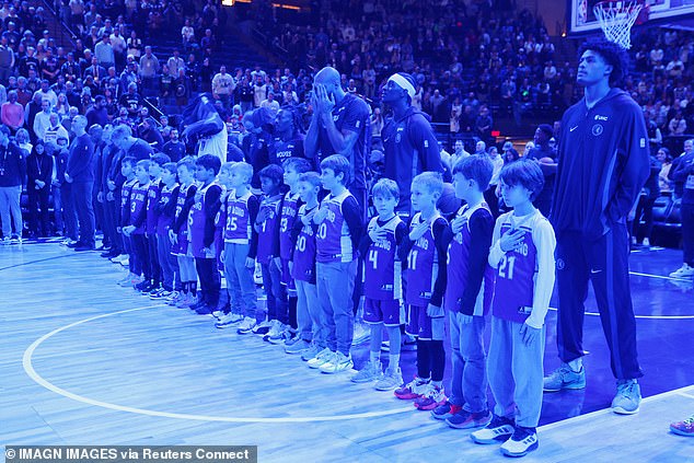 The Minnesota Timberwolves players line up with a youth team and honor Renee Good with a moment of silence before the game with the Cleveland Cavaliers at Target Center