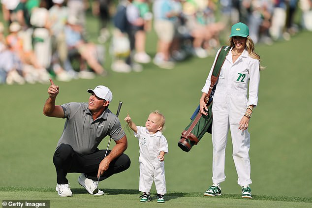 Jena Sims Koepka (right) posted a picture of the family at Augusta National before her husband's PGA return this week. The photo (similar the one seen here) shows their son, Crew