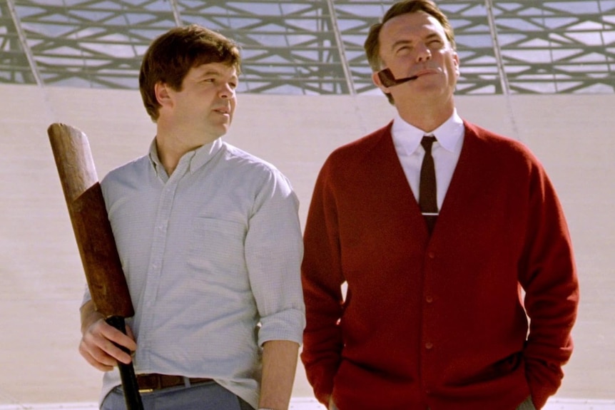 Two men stand side by side in a scene from movie The Dish.