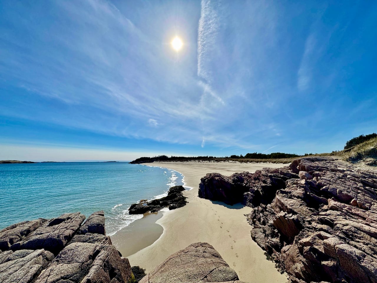 Rocks on a sandy beach on a sunny day 