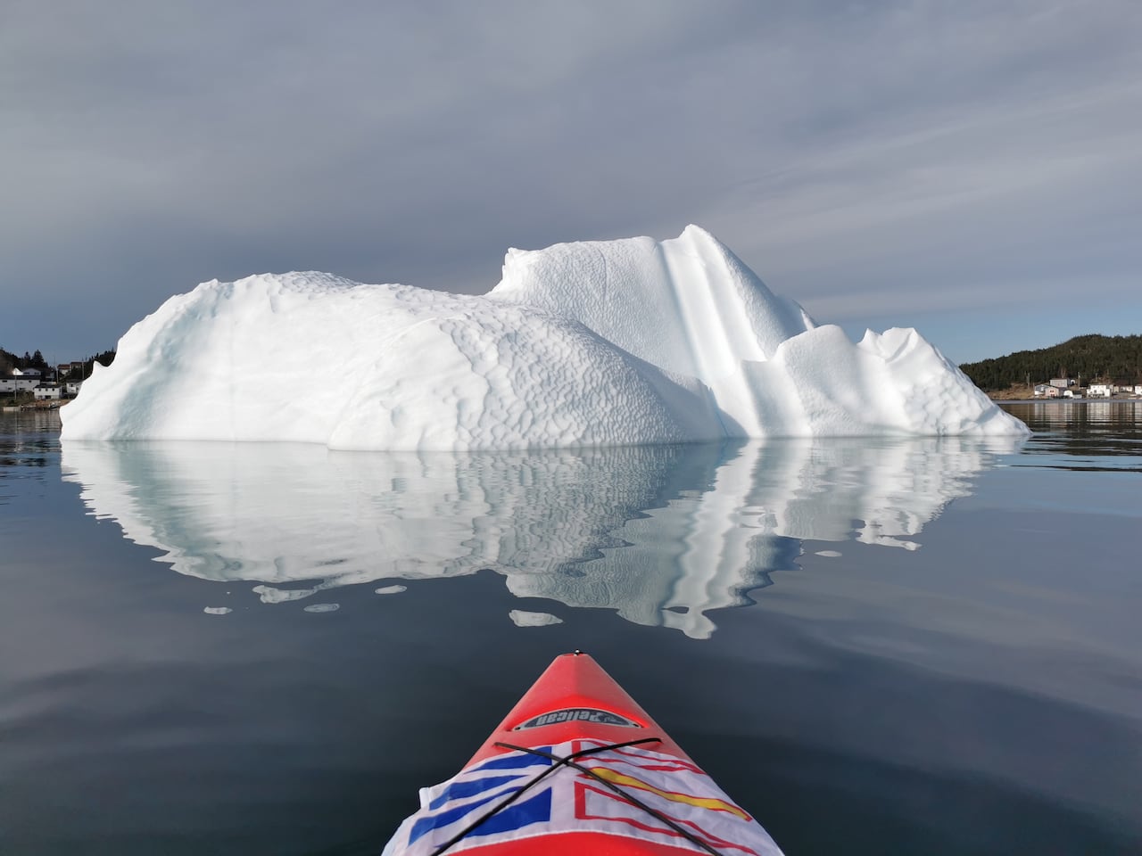 A photo of an iceberg taken from a kayak.
