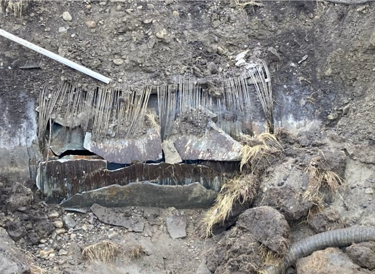 A ruptured piece of pipe in the ground