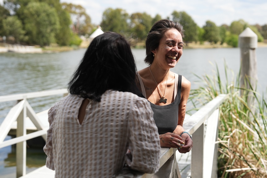 A young woman laughs with her mother.