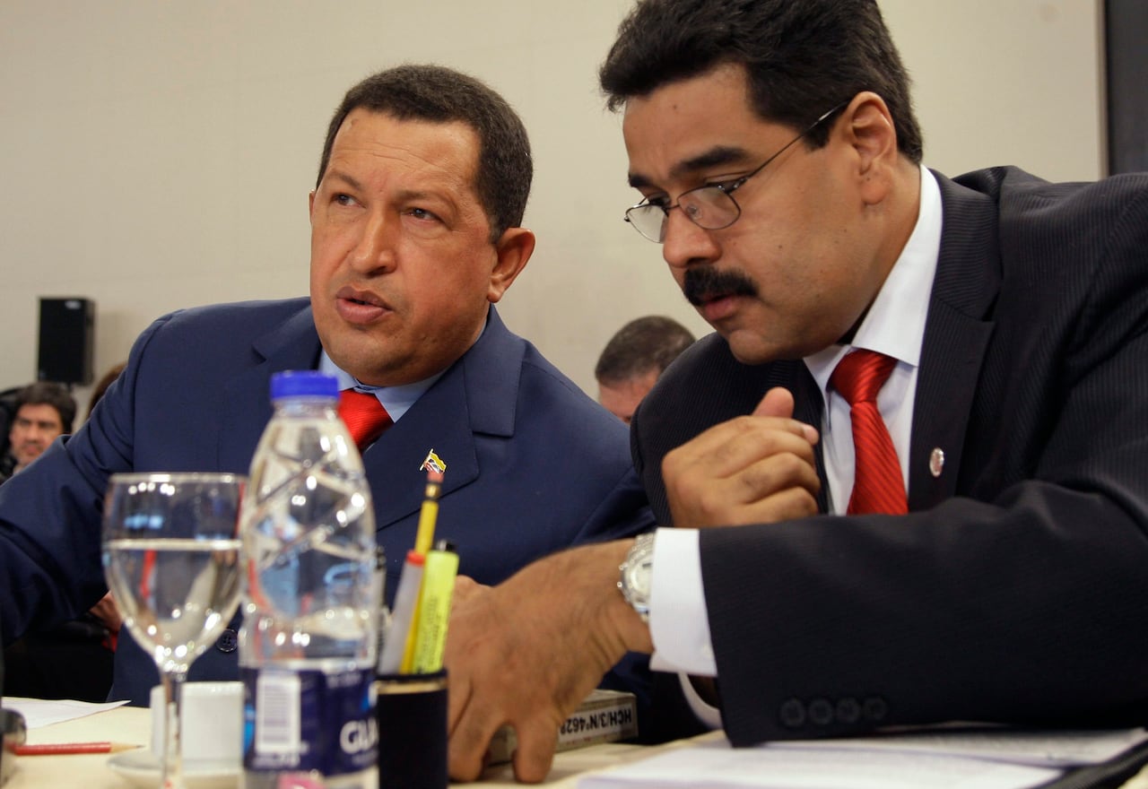 Two people are seen seated at a table.