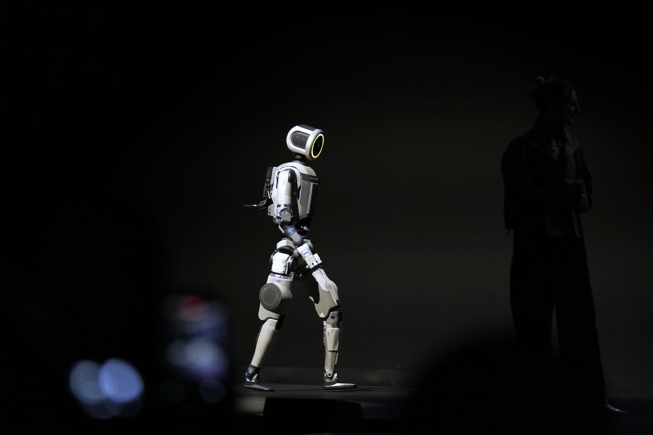 A robot walking across a stage.
