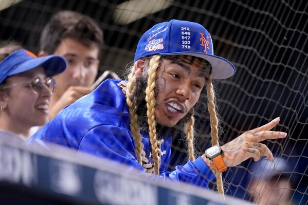 Rapper Tekashi 6ix9ine watches a baseball game between the Miami Marlins and New York Mets, Aug. 3, 2021, in Miami. (AP Photo/Lynne Sladky, File)