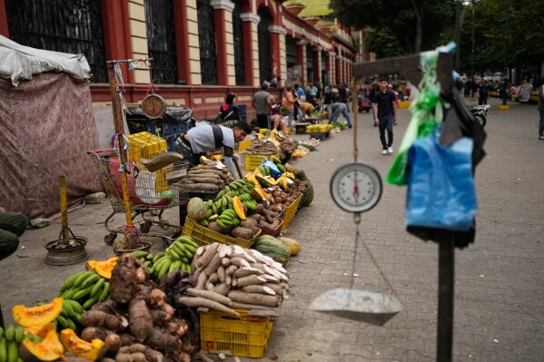 Vendors display vegetables at a street market in Caracas, Venezuela, Thursday, Jan. 8, 2026. (AP Photo/Matias Delacroix)