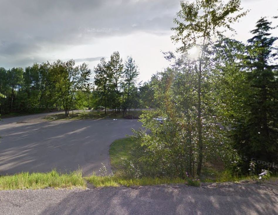 A nondescript rest area next to a highway.