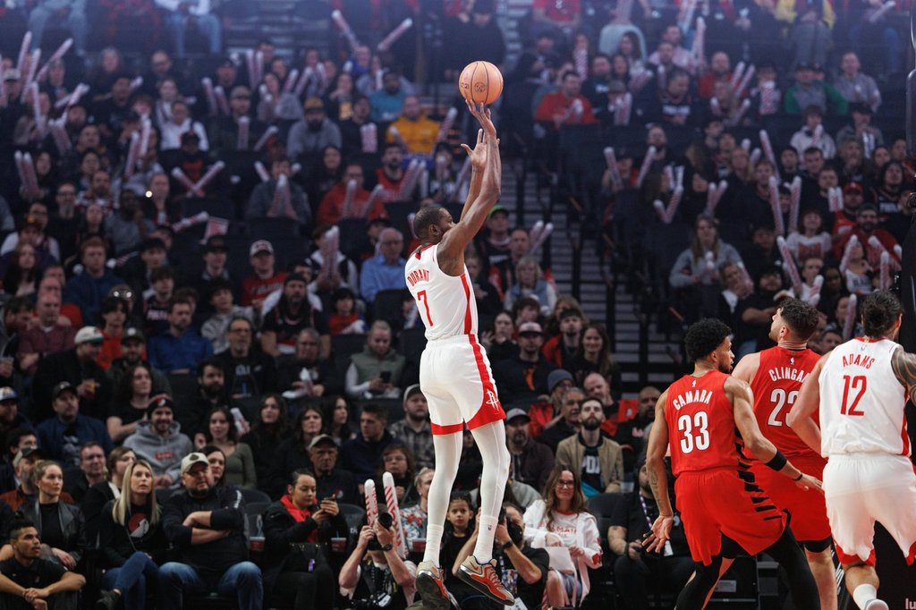 Houston Rockets forward Kevin Durant, center, shoots against the Portland Trail Blazers during the first half of an NBA basketball game Friday, Jan. 9, 2026, in Portland, Ore. (AP Photo/Howard Lao)
