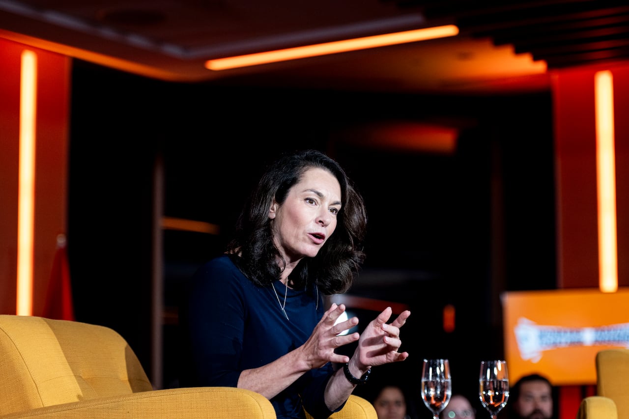 A woman speaks sitting in a chair