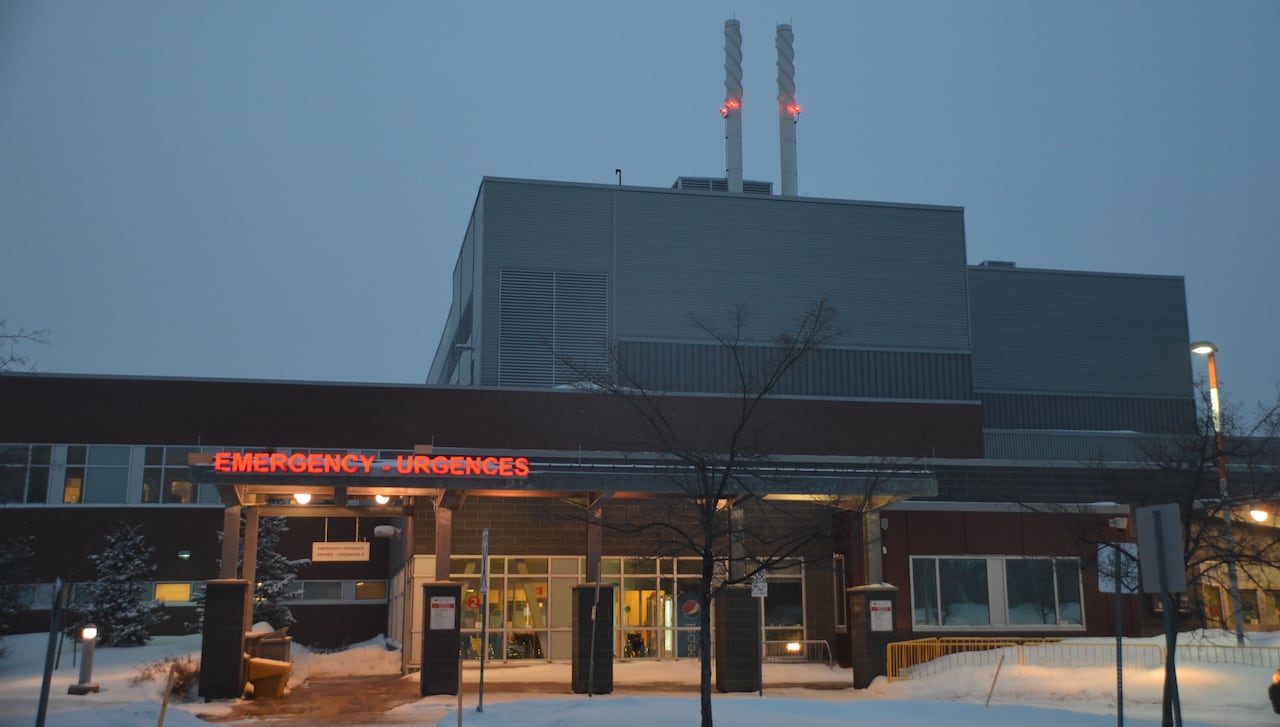 A large building with a red sign that says "emergency" at the front.