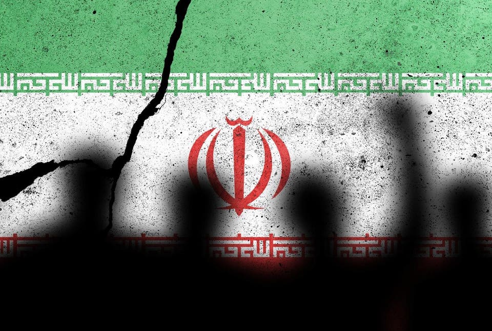 Flags of Iran painted on the concrete wall with protesting people