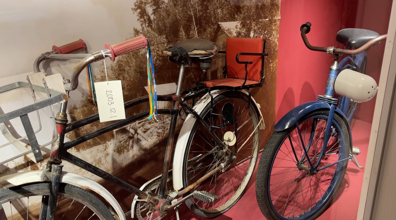 Old bikes in a display case 
