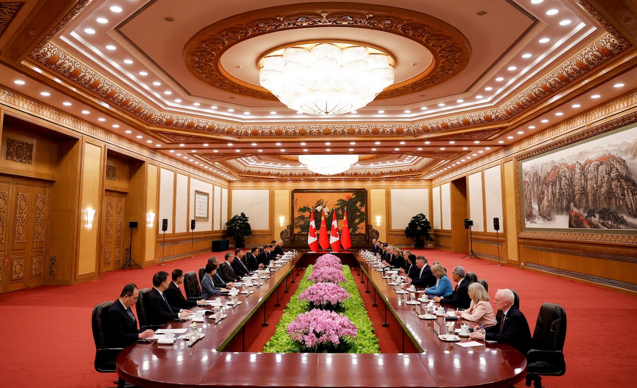 Officials are seen seated at a long table.
