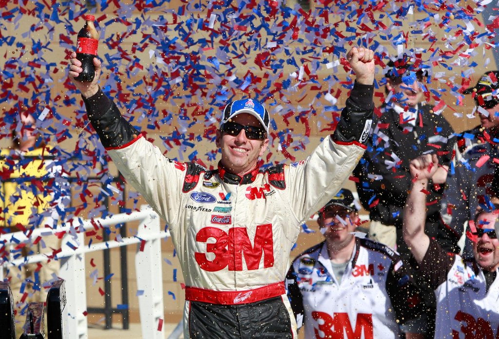 FILE - Greg Biffle celebrates in victory lane after winning the NASCAR Sprint Cup Series auto race at Kansas Speedway on Sunday, Oct. 3, 2010, in Kansas City, Kan. (AP Photo/Orlin Wagner, File)