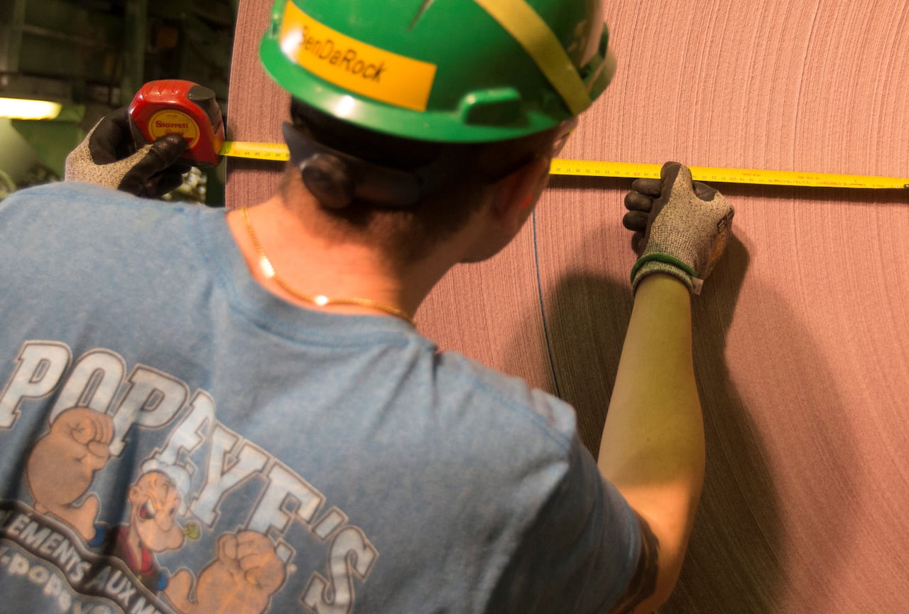 A person works in a paper mill.