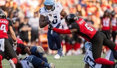 Toronto Argonauts running back Kevin Brown (6) jumps in the air as Ottawa Redblacks linebacker Adarius Pickett (6) makes a tackle during first half CFL football action in Ottawa, on Sunday, June 29, 2025. THE CANADIAN PRESS/Spencer Colby