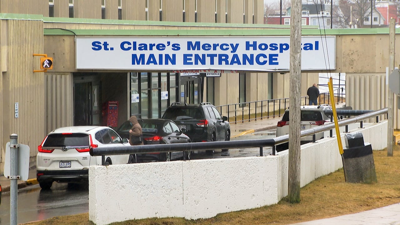 Hospital entrance with cars and people
