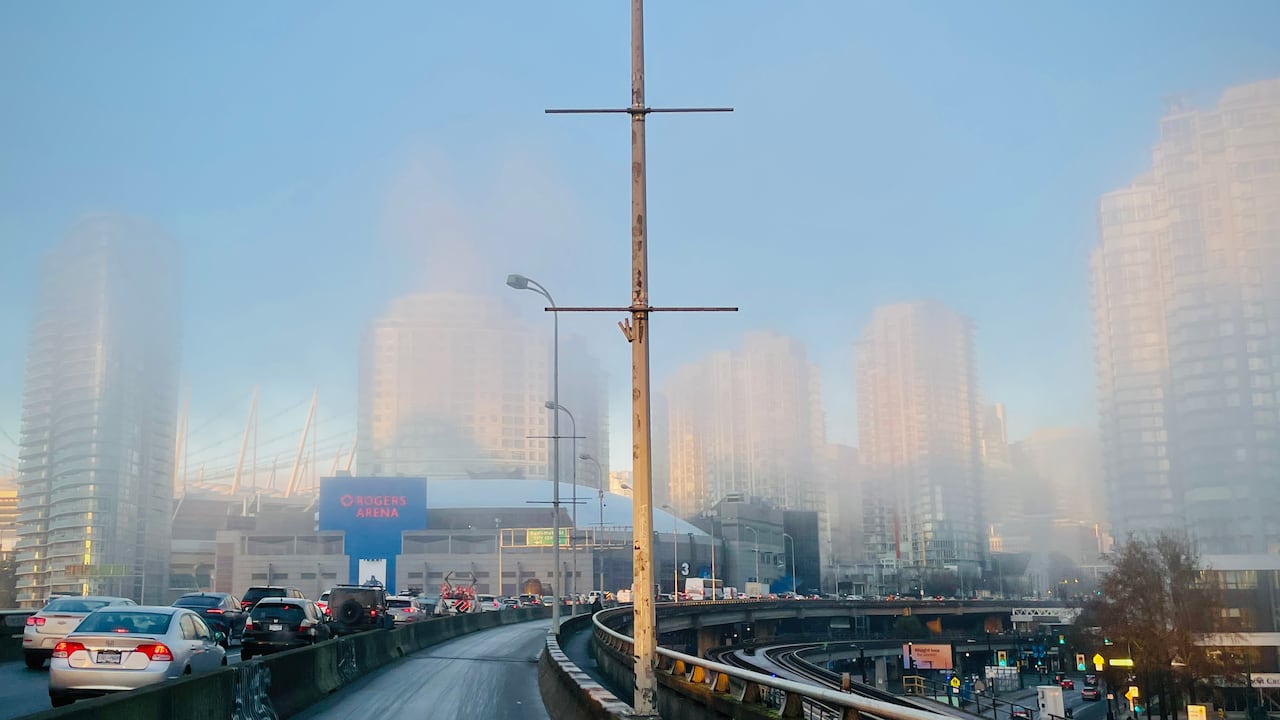 Traffic in downtown Vancouver on a foggy day.