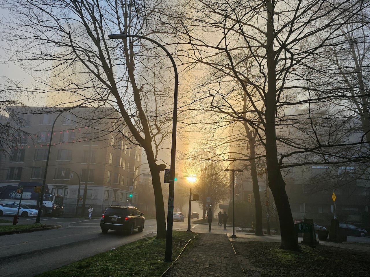 Sun peaks through fog in downtown Vancouver.