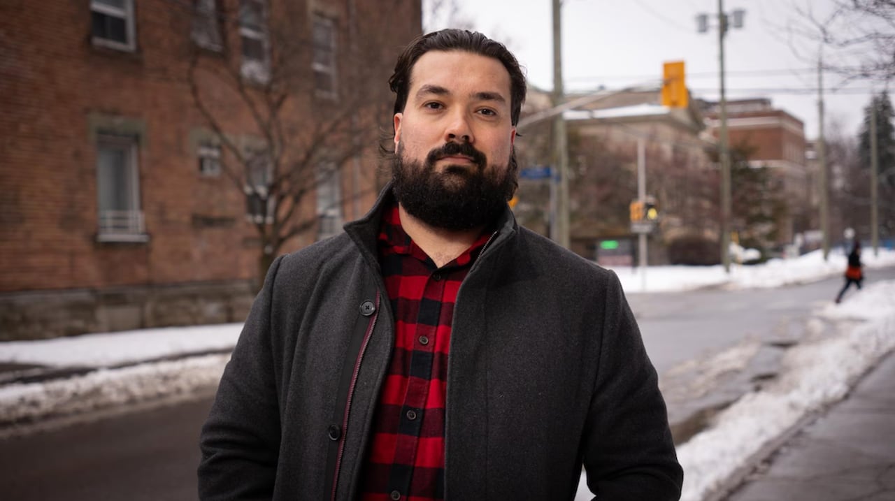 A vice-president of a union stands in front of a snowy street.