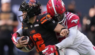 B.C. Lions quarterback Nathan Rourke, front left, is sacked by Calgary Stampeders