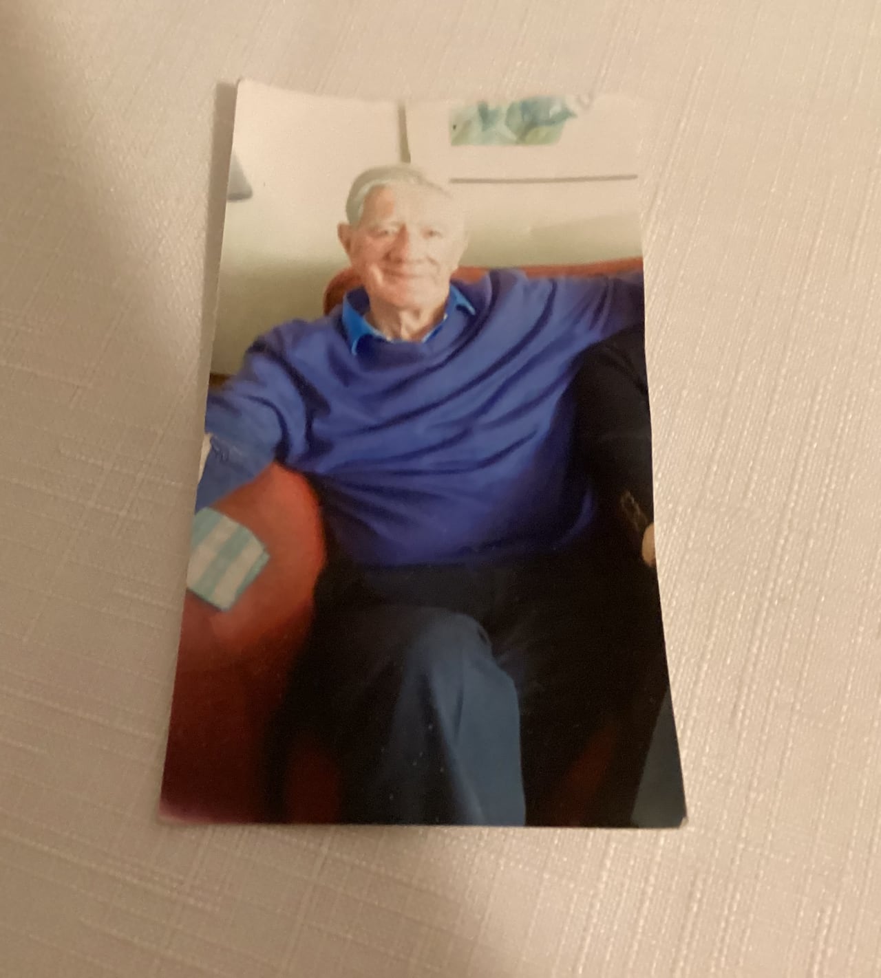A picture of an older white man sits on a table.