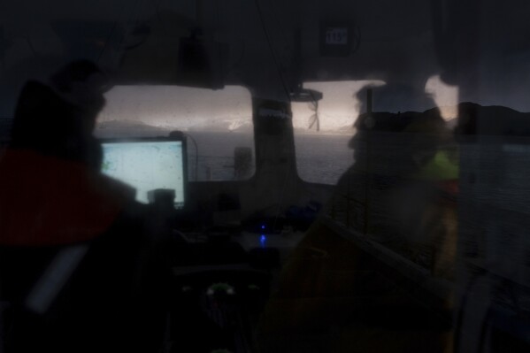 Bally Philp and his crew member take the boat out to their creels on Nov. 20, 2025, in Loch Alsh off the coast of Kyleakin, Scotland. (AP Photo/Emily Whitney)