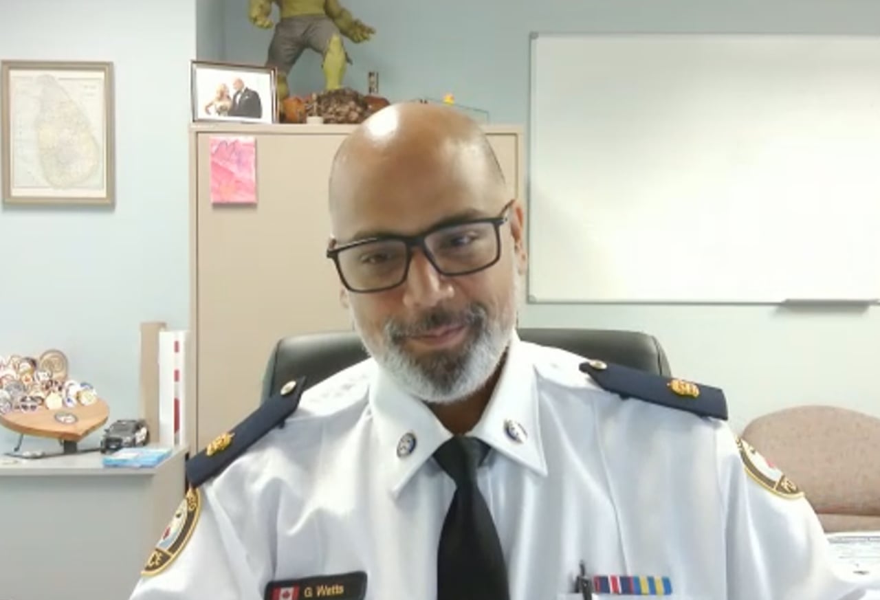 A man is wearing a white police uniform.