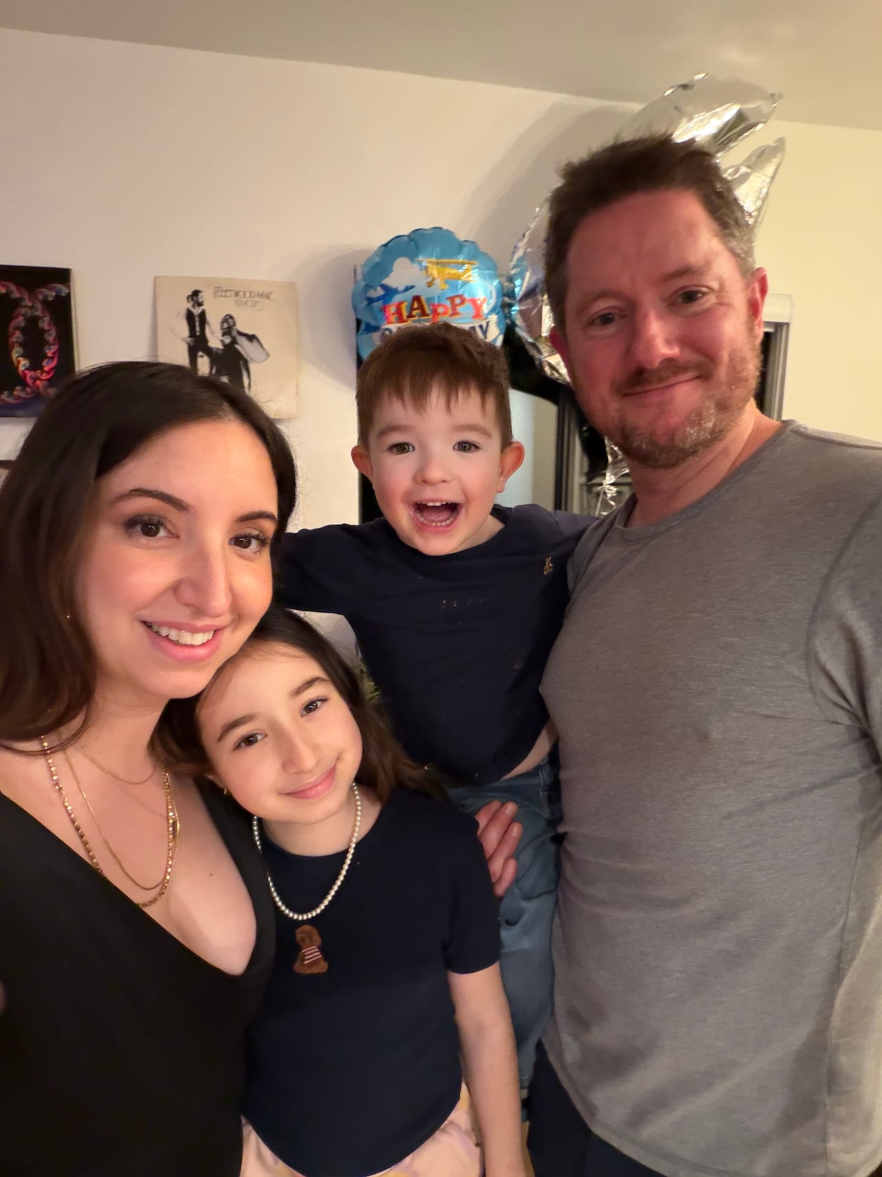 A mother and father poses with her 11-year-old daughter and four-year-old son