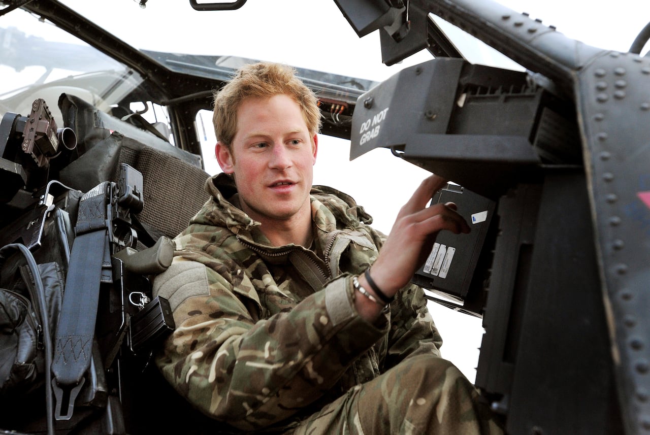 A young British soldier adjusts pre-flight controls in his aircraft.