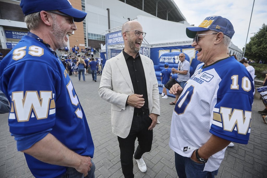 Stewart Johnson, CFL Commissioner, talks with Winnipeg Blue Bomber fans in a “tail gate party” area prior to the Winnipeg Blue Bombers and Edmonton Elks game in Winnipeg, Thursday, June 26, 2025. THE CANADIAN PRESS/John Woods