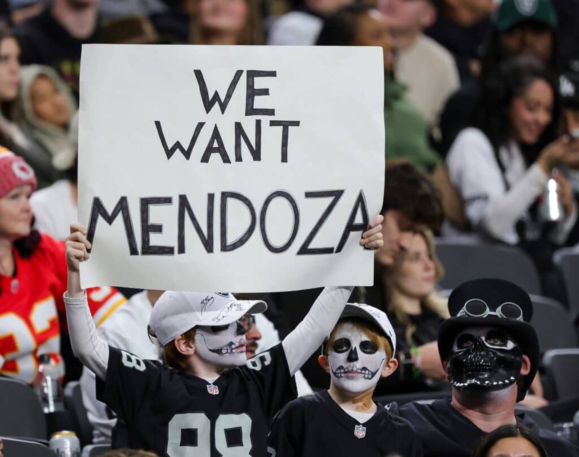 A Las Vegas Raiders fan holds up a sign for Fernando Mendoza