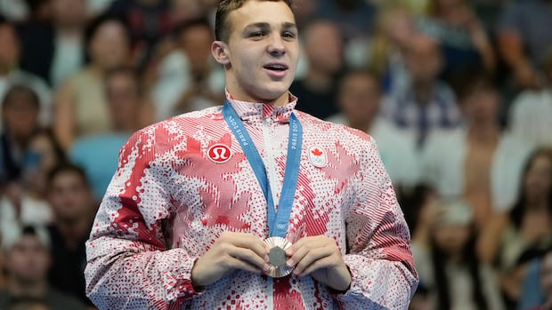 Canadian swim star Ilya Kharun, who won 2 bronze medals at Paris Olympics, says he'll now compete for U.S.