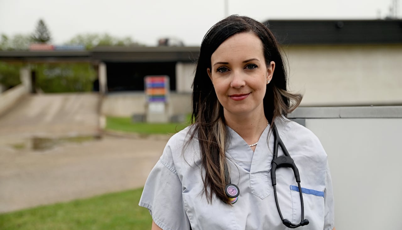A woman wearing doctor's clothing with a stethoscope. 
