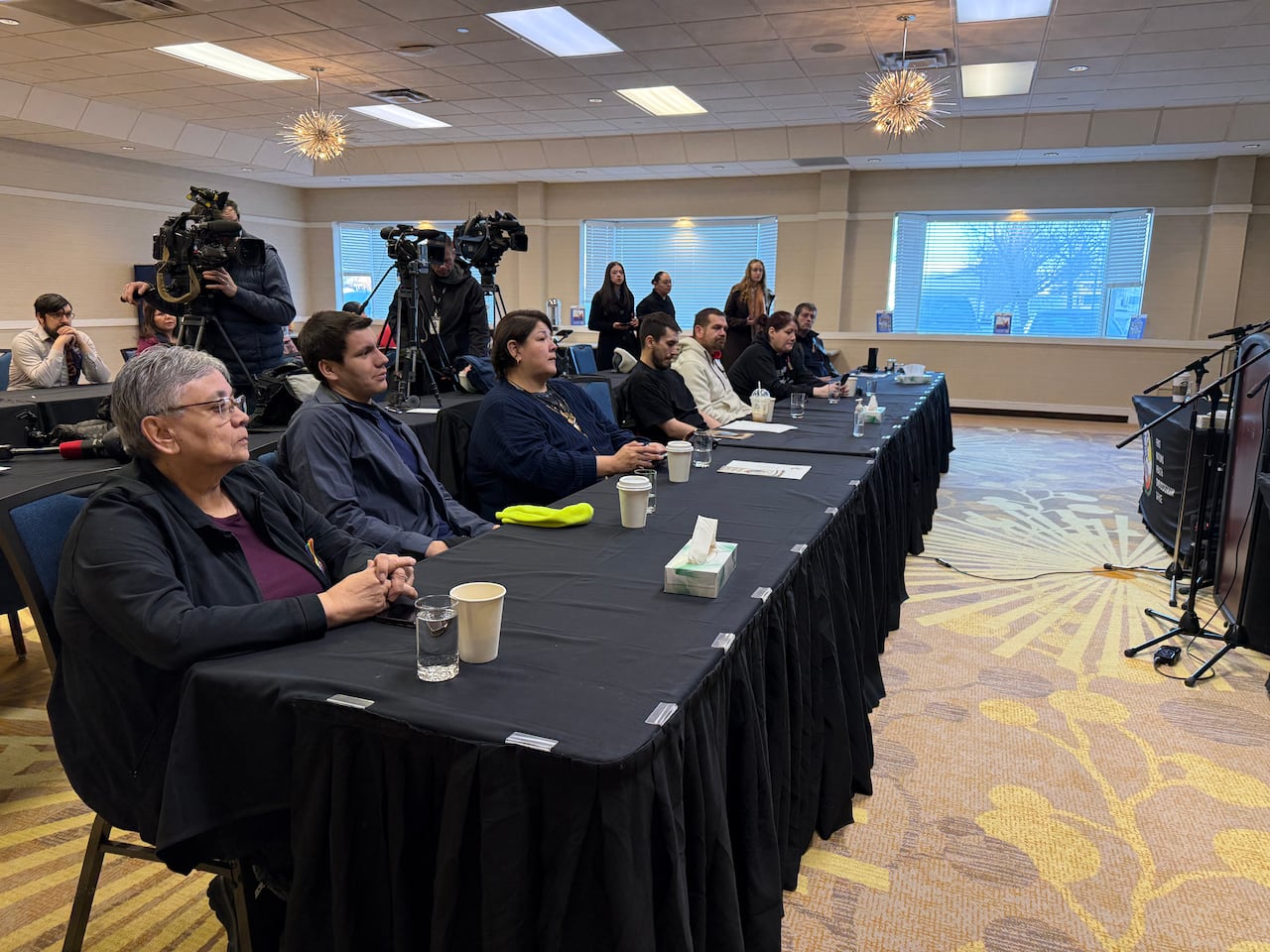 People sitting behind a desk. 