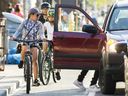 Cyclists are seen on an eastbound bike lane along Bloor St. W. near Ossington Ave. in Toronto on Thursday August 6, 2020.