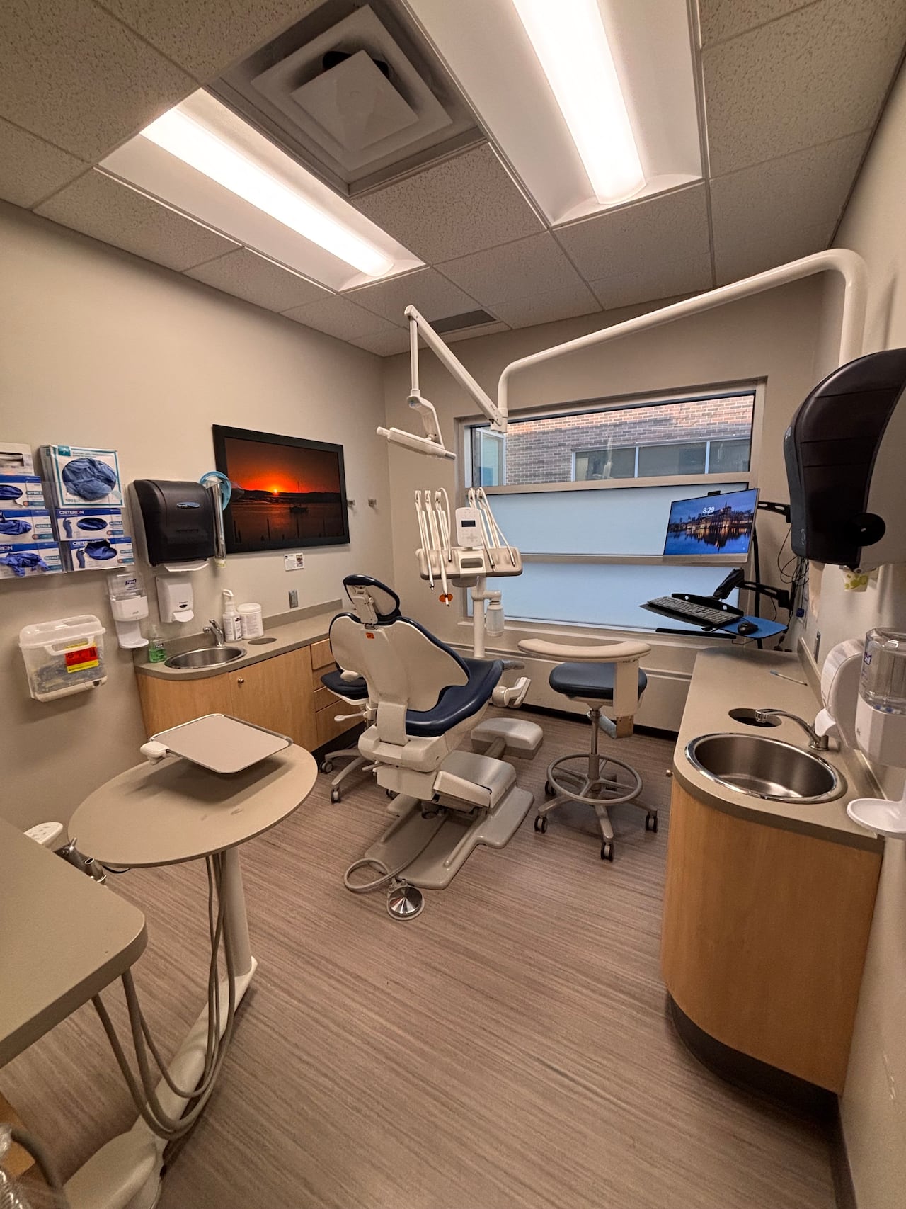 An empty patient chair inside a dental suite.