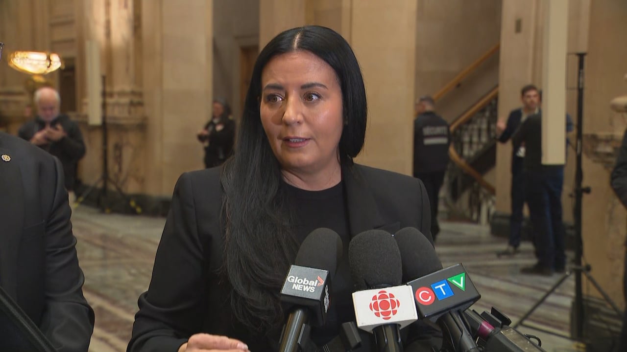 Montreal mayor Soraya Martinez Ferrada stands in front of microphones in foyer of Montreal city hall