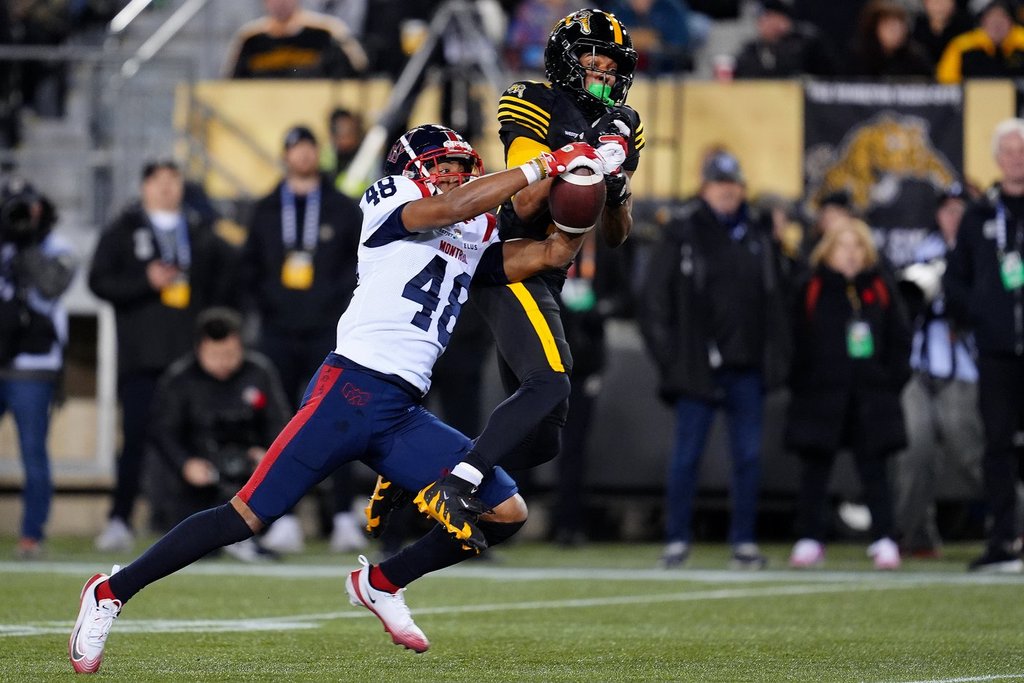 Montreal Alouettes defensive back Kabion Ento (48) breaks up a pass to Hamilton Tiger-Cats wide receiver Tim White (12) during second half CFL eastern final football action in Hamilton, Ont., Saturday, Nov. 8, 2025. THE CANADIAN PRESS/Frank Gunn