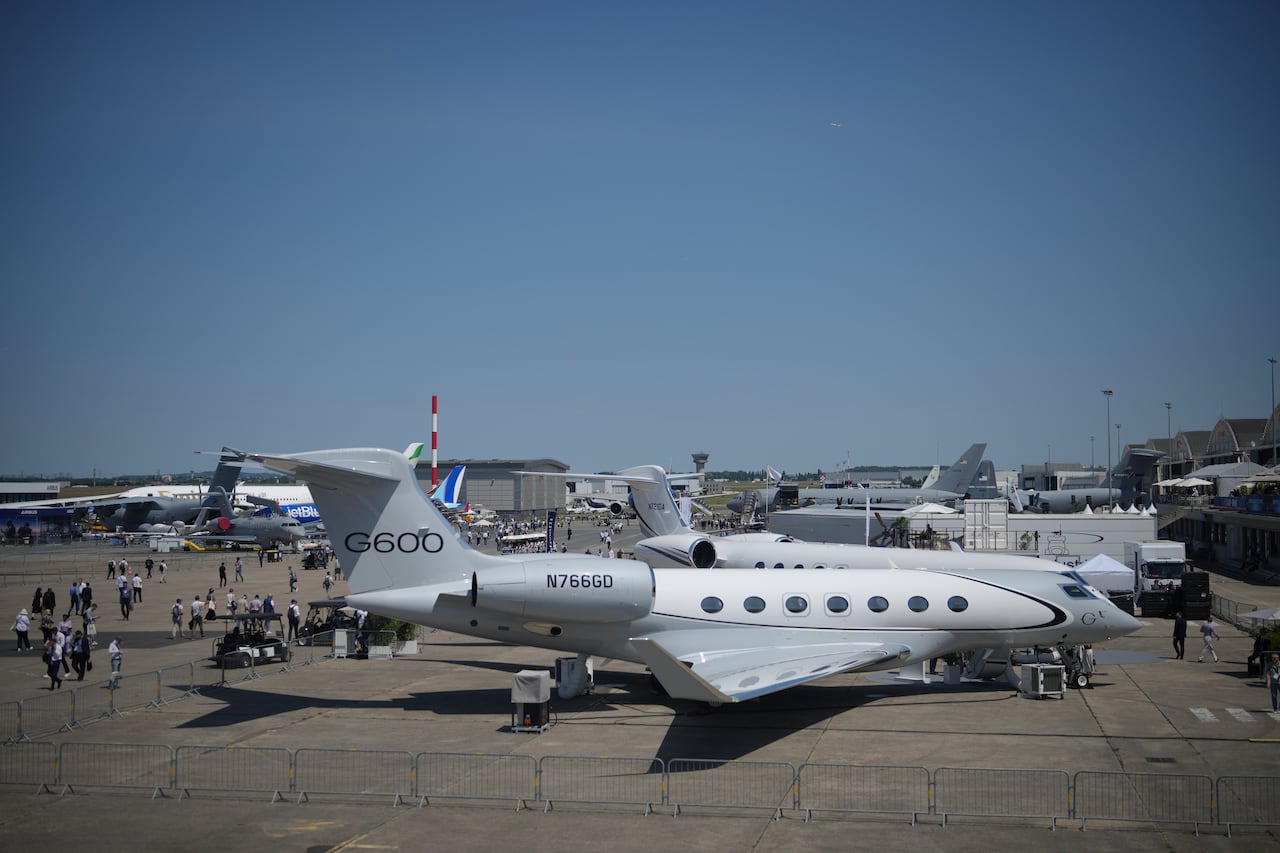 A row of planes are shown on a tarmac.
