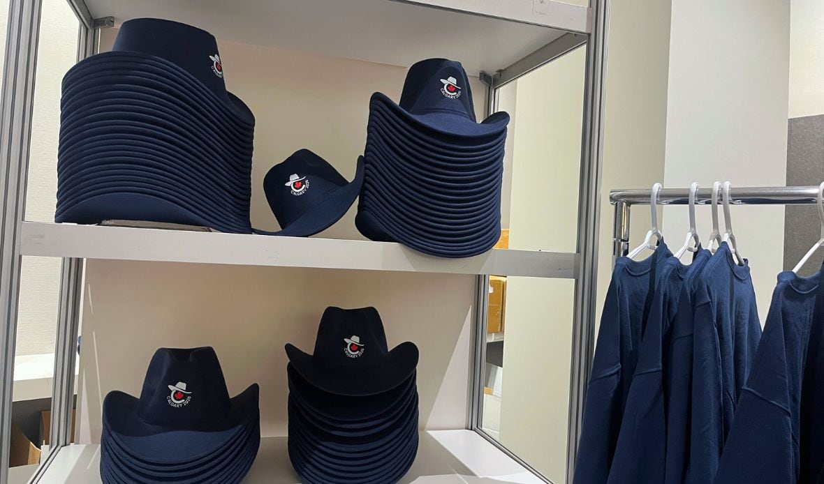 Cowboy hats are stacked in a room.