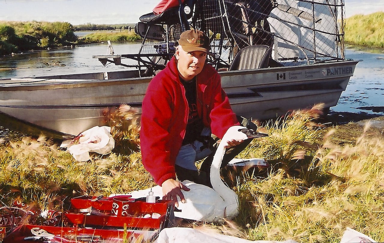 A man holding a swan.