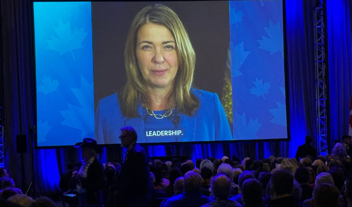 A woman's face is shown on-screen.