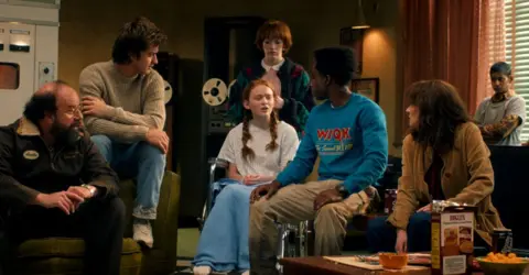 Netflix Brett Gelman, Joe Keery, Sadie Sink, Amybeth McNulty, Caleb McLaughlin, Winona Ryder and Linnea Berthelsen in Stranger Things