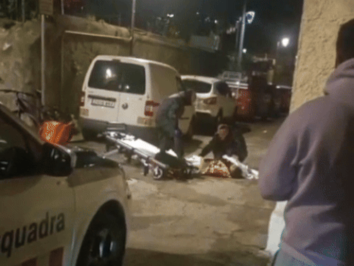 Police taking possession of the body and taking it to hospital.